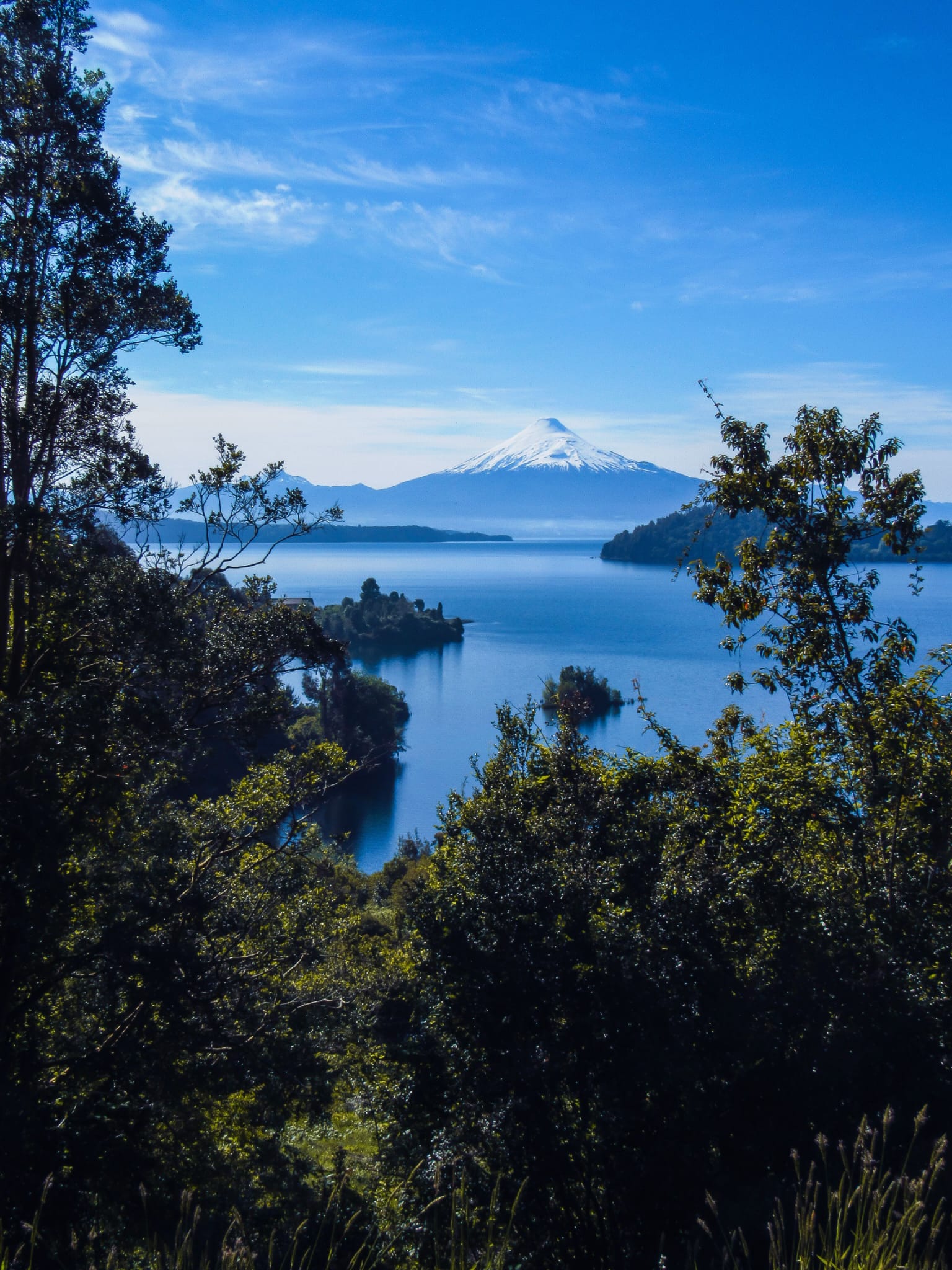 Osorno volcano seen through native forest and lake, Chile